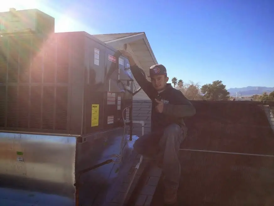 HVAC technician performing HVAC Inspection on a rooftop unit in Anderson